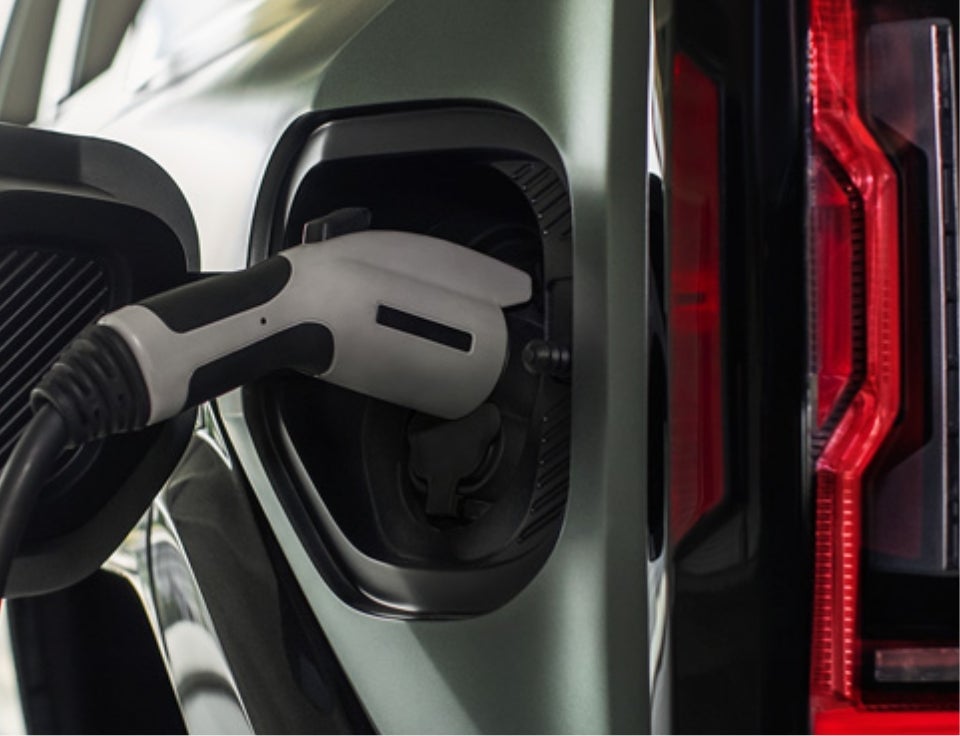 Close up of charging port with charger plugged in on a GMC Hummer EV SUV - Tawes Brothers GMC in CRISFIELD MD